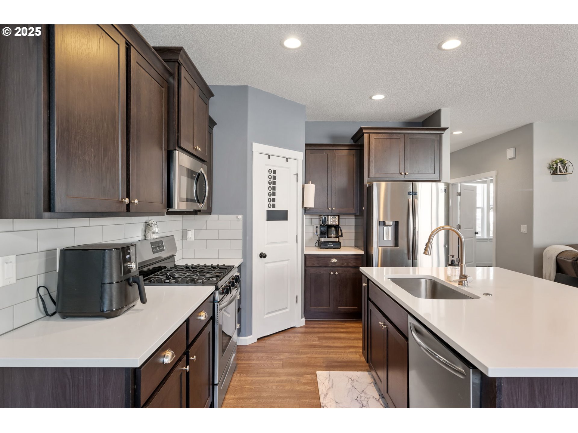 2820 Southeast Baker Avenue Gresham, OR 97080 - Photo 8 of 33 a kitchen with a refrigerator and a sink