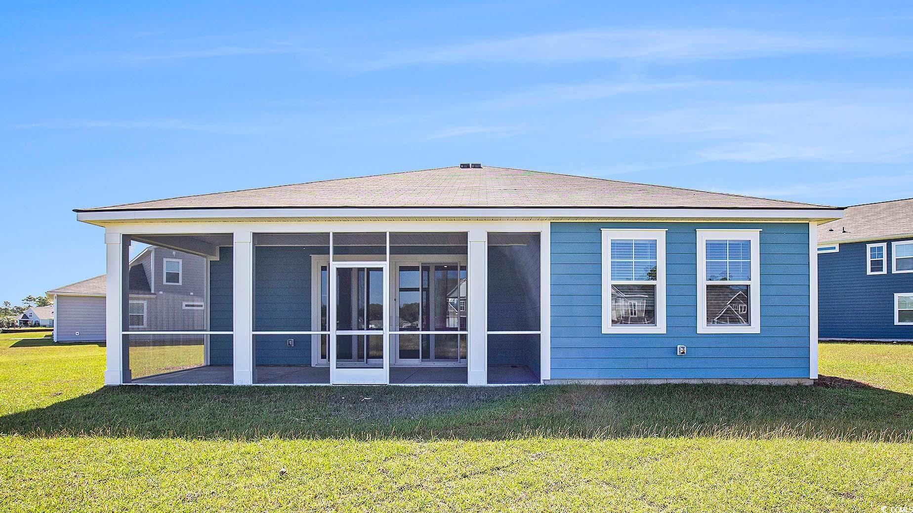 509 Crookhaven Court Conway, SC 29526 - Photo 2 of 37 Back of house with a yard, a sunroom, and a shingled roof