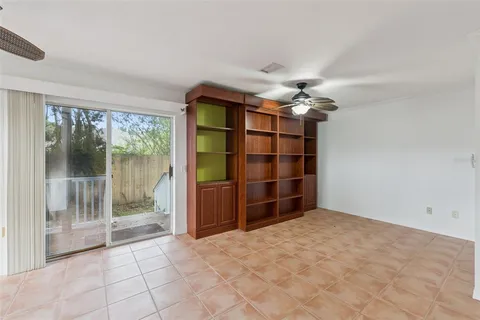 a view of a livingroom with a ceiling fan and window