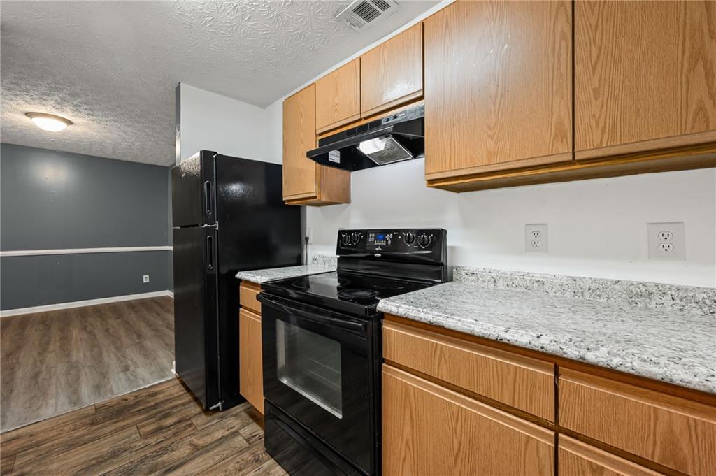 3303 Par 3 Way Lithonia, GA 30038 - Photo 12 of 27 a kitchen with stainless steel appliances granite countertop a refrigerator and a sink