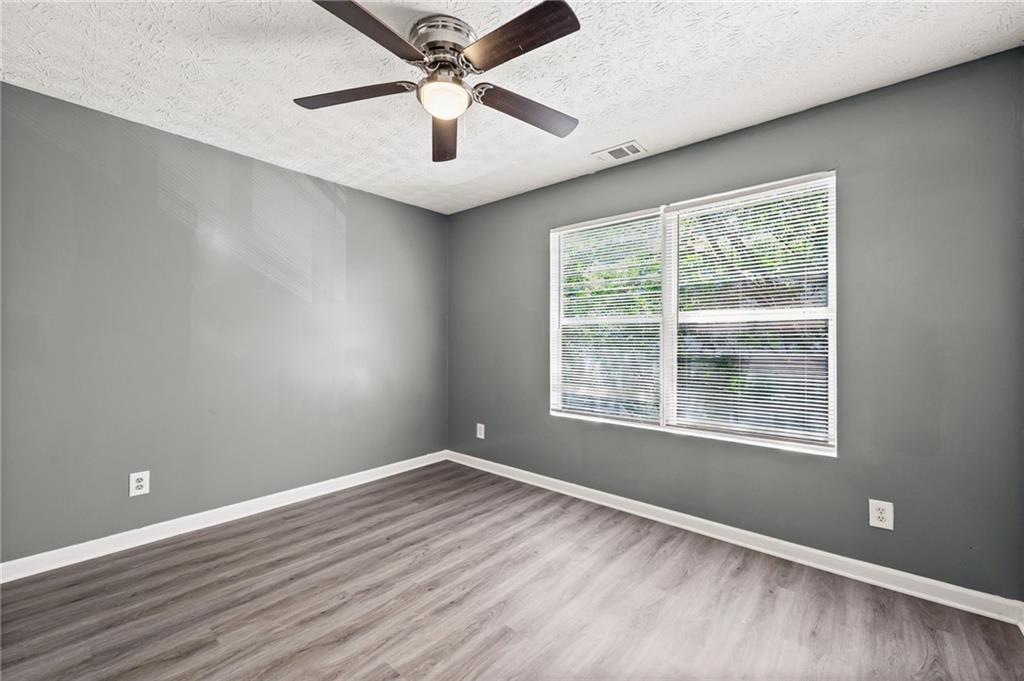 3303 Par 3 Way Lithonia, GA 30038 - Photo 13 of 27 wooden floor in an empty room with a window