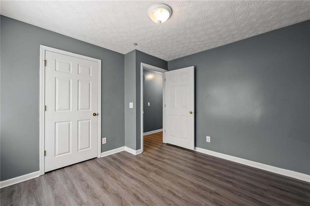 3303 Par 3 Way Lithonia, GA 30038 - Photo 20 of 27 an empty room with wooden floor and closet area
