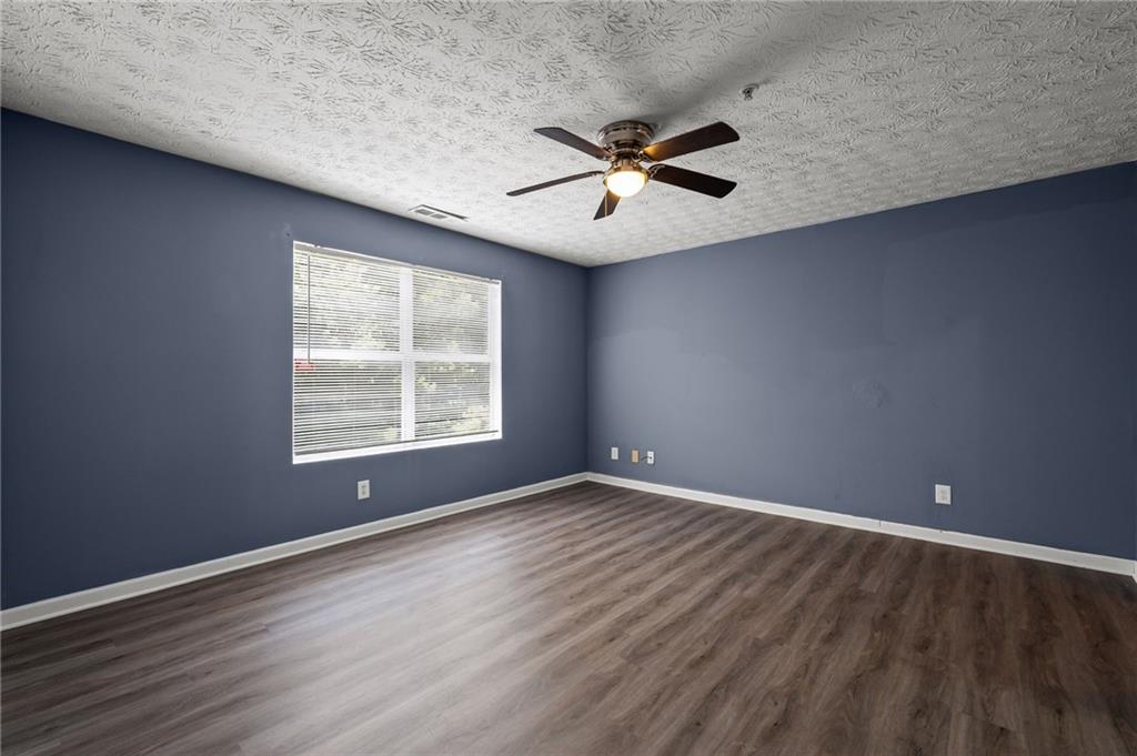 3303 Par 3 Way Lithonia, GA 30038 - Photo 22 of 27 a view of an empty room with wooden floor and a window