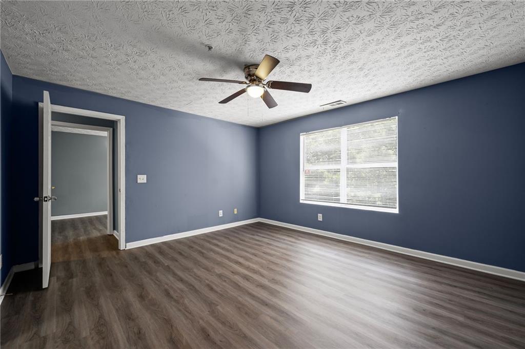 3303 Par 3 Way Lithonia, GA 30038 - Photo 25 of 27 wooden floor in an empty room with a window