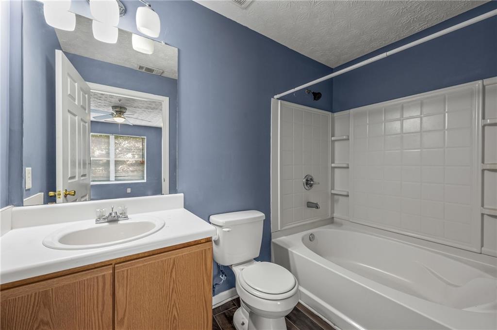 3303 Par 3 Way Lithonia, GA 30038 - Photo 26 of 27 a bathroom with a sink a toilet and shower