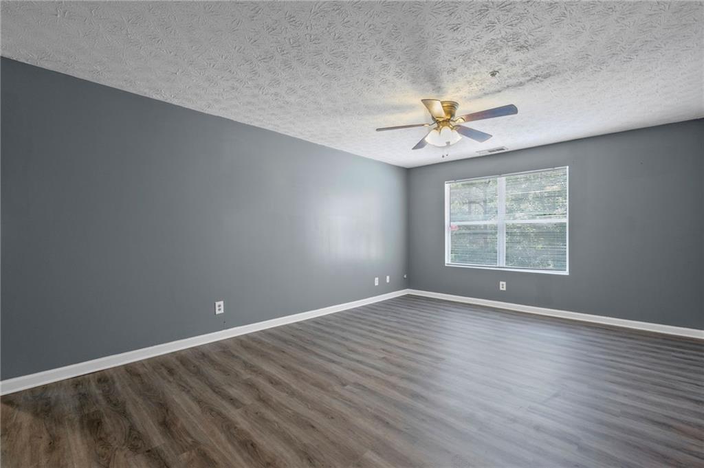 3303 Par 3 Way Lithonia, GA 30038 - Photo 3 of 27 wooden floor in an empty room with a window