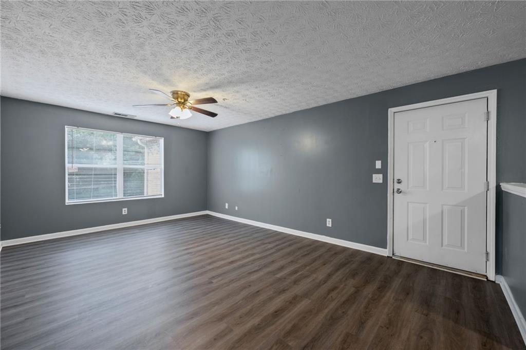3303 Par 3 Way Lithonia, GA 30038 - Photo 6 of 27 an empty room with wooden floor and windows