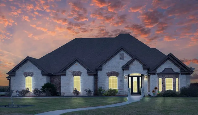 a front view of a house with a garden