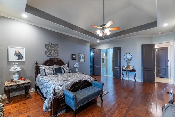 a bedroom with a bed and a chandelier