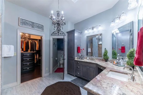 a spacious bathroom with a double vanity sink and a mirror