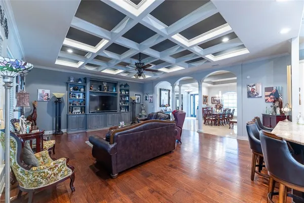 a living room with furniture and wooden floor