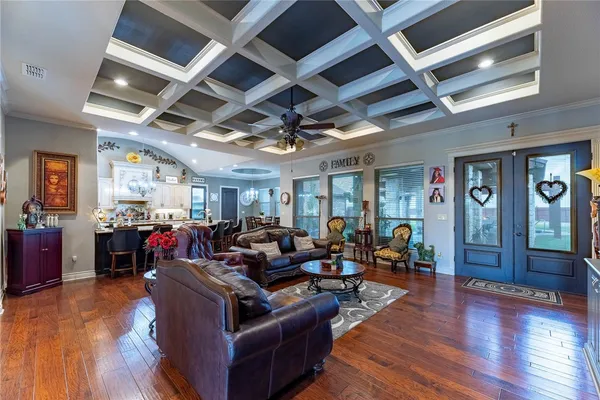a living room with lots of furniture and hard wood flooring