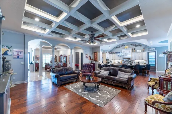 a living room with lots of furniture and kitchen view