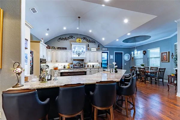 a kitchen with counter space dining table and chairs