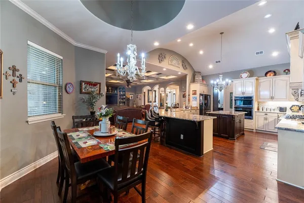 a large kitchen with a table and chairs