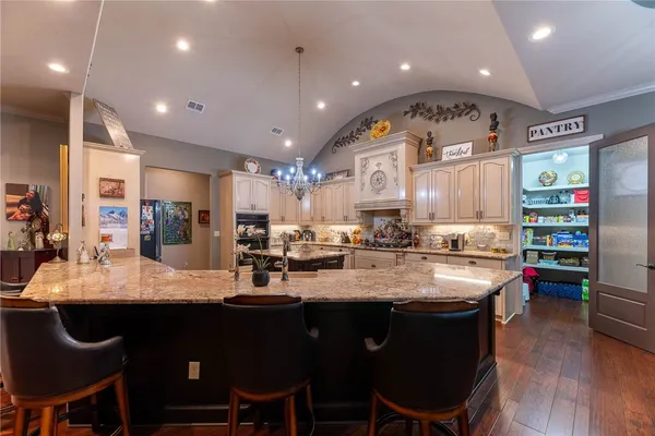 a large kitchen with a table and chairs