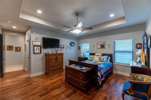 a bedroom with furniture and a flat screen tv