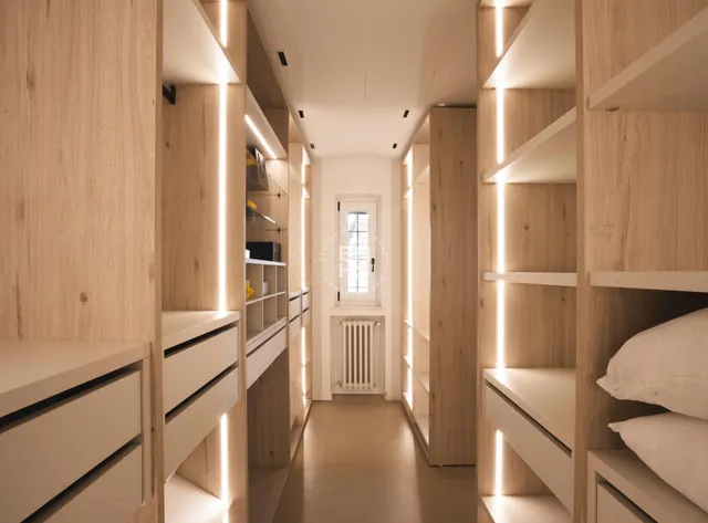 a kitchen with a refrigerator and wooden floor