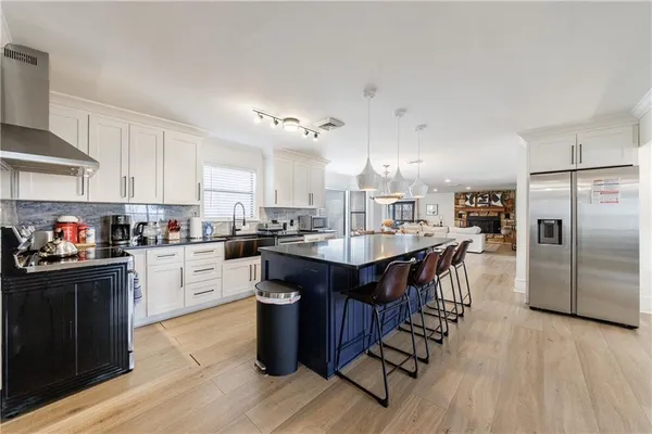 a kitchen with granite countertop white cabinets and white appliances