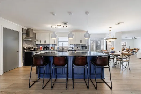 a kitchen with stainless steel appliances granite countertop a stove a sink and a refrigerator