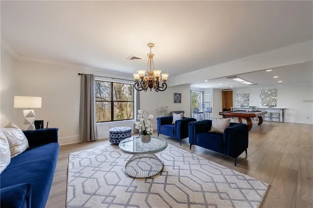 a living room with furniture a window and a table