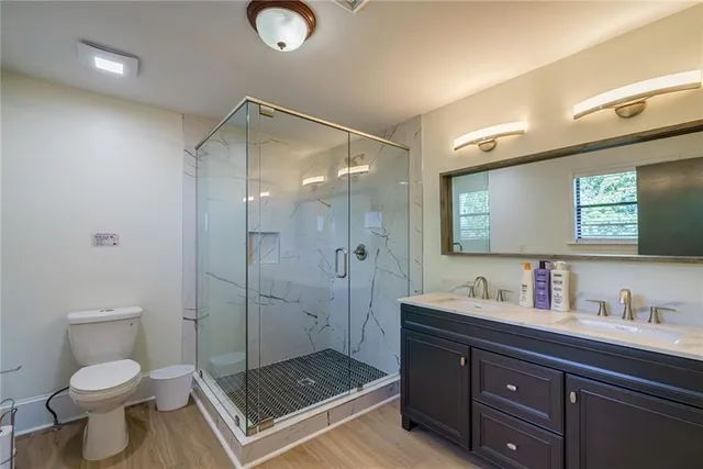 a bedroom with a large bed a flat tv screen and a dresser