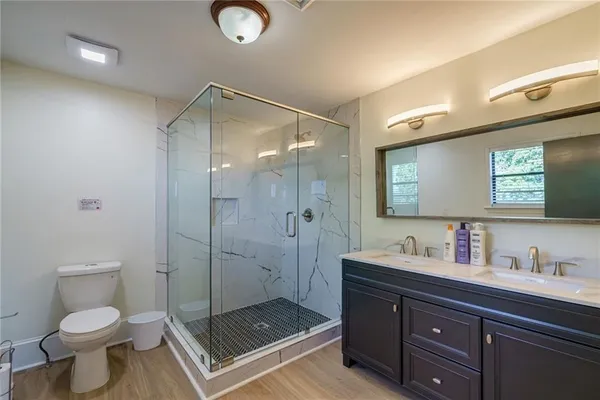 a view of hallway with stairs and wooden floor
