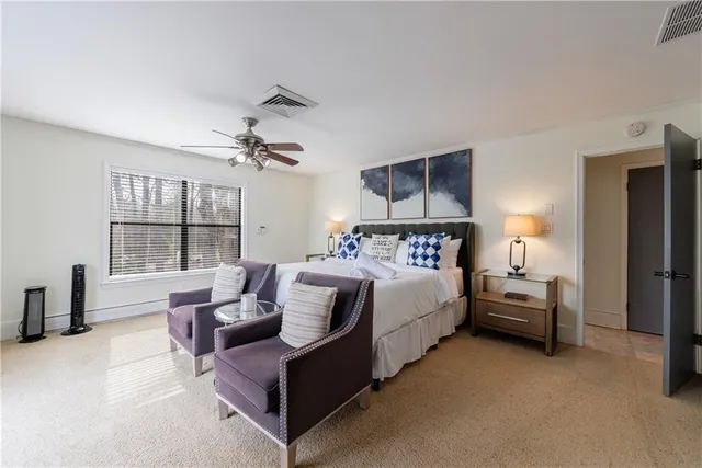 a aerial view of a house with a yard and lake view