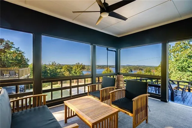 a view of a city from a balcony with outdoor seating