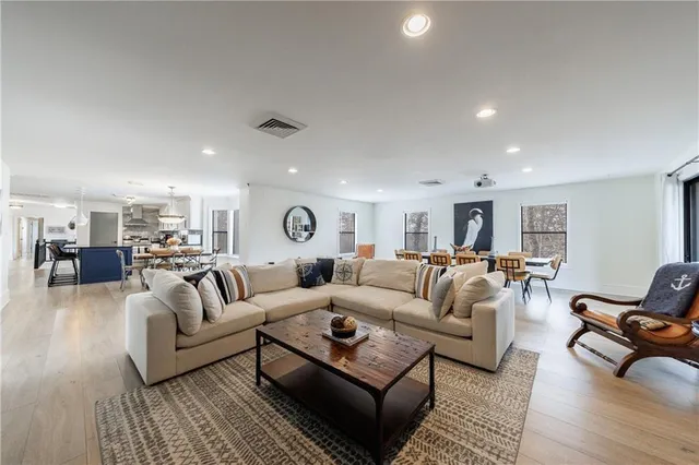a living room with lots of furniture and a chandelier