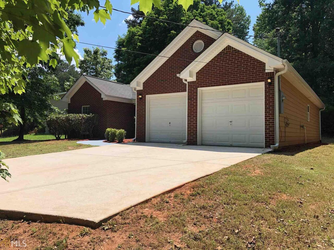 3729 Manhattan Drive Decatur, GA 30034 - Photo 1 of 1 a front view of a house with a yard and garage