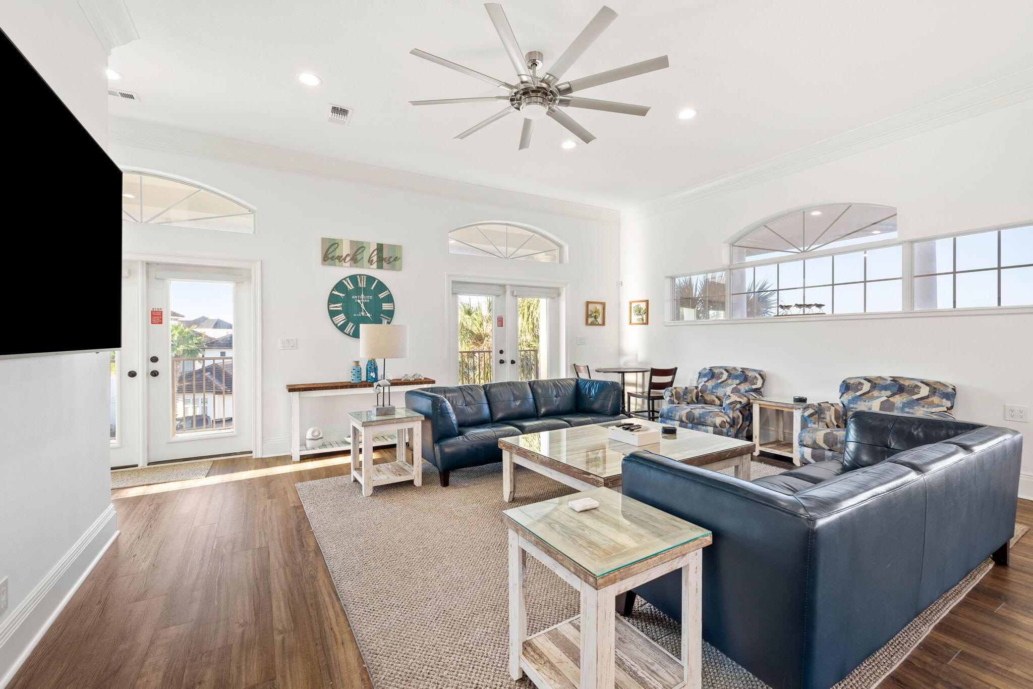 9 St Barts Bay Destin, FL 32541 - Photo 3 of 33 a living room with furniture a chandelier and a flat screen tv