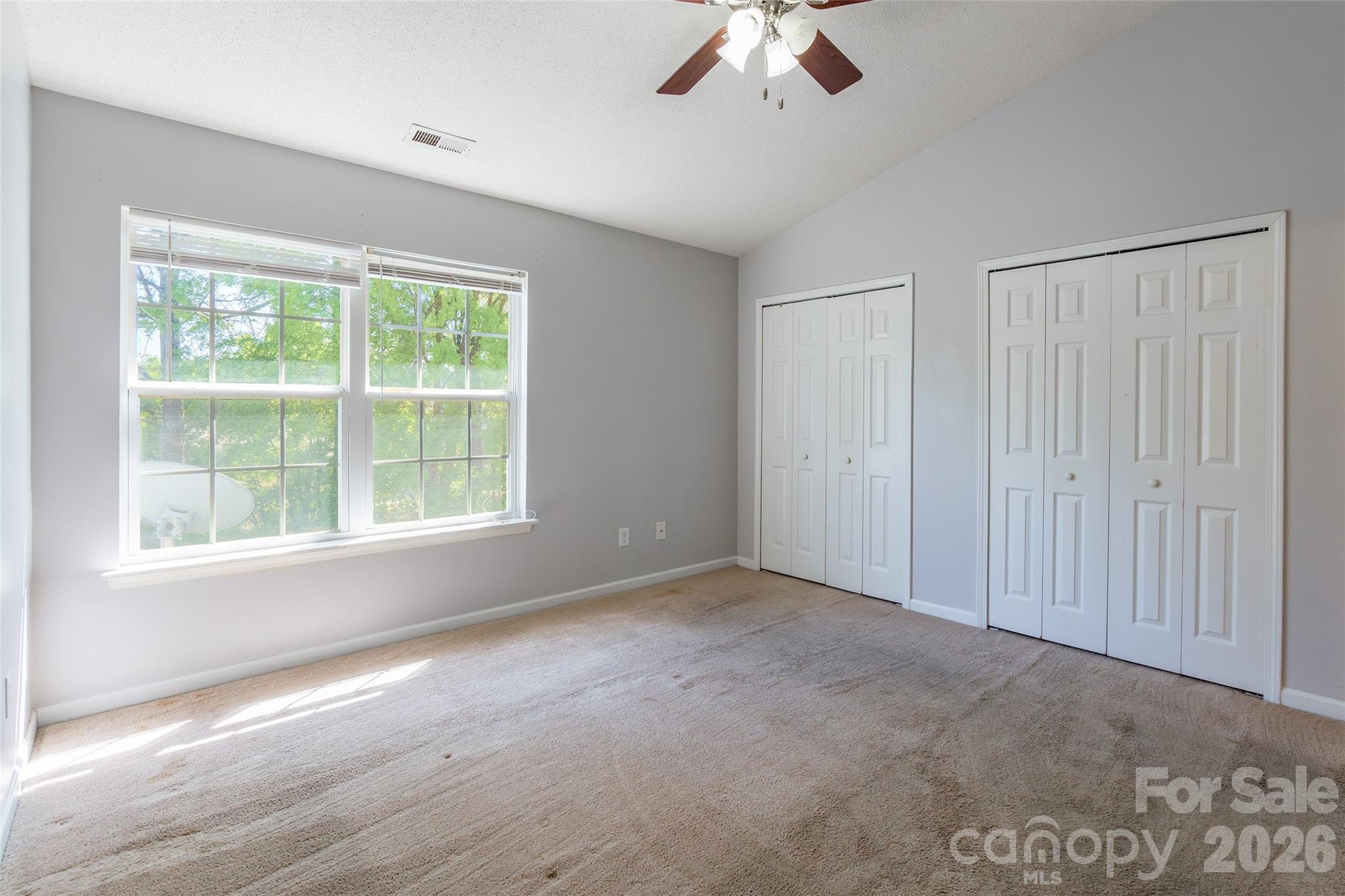 4024 Ashby Lane Fort Mill, SC 29707 - Photo 12 of 21 an empty room with a chandelier fan and windows