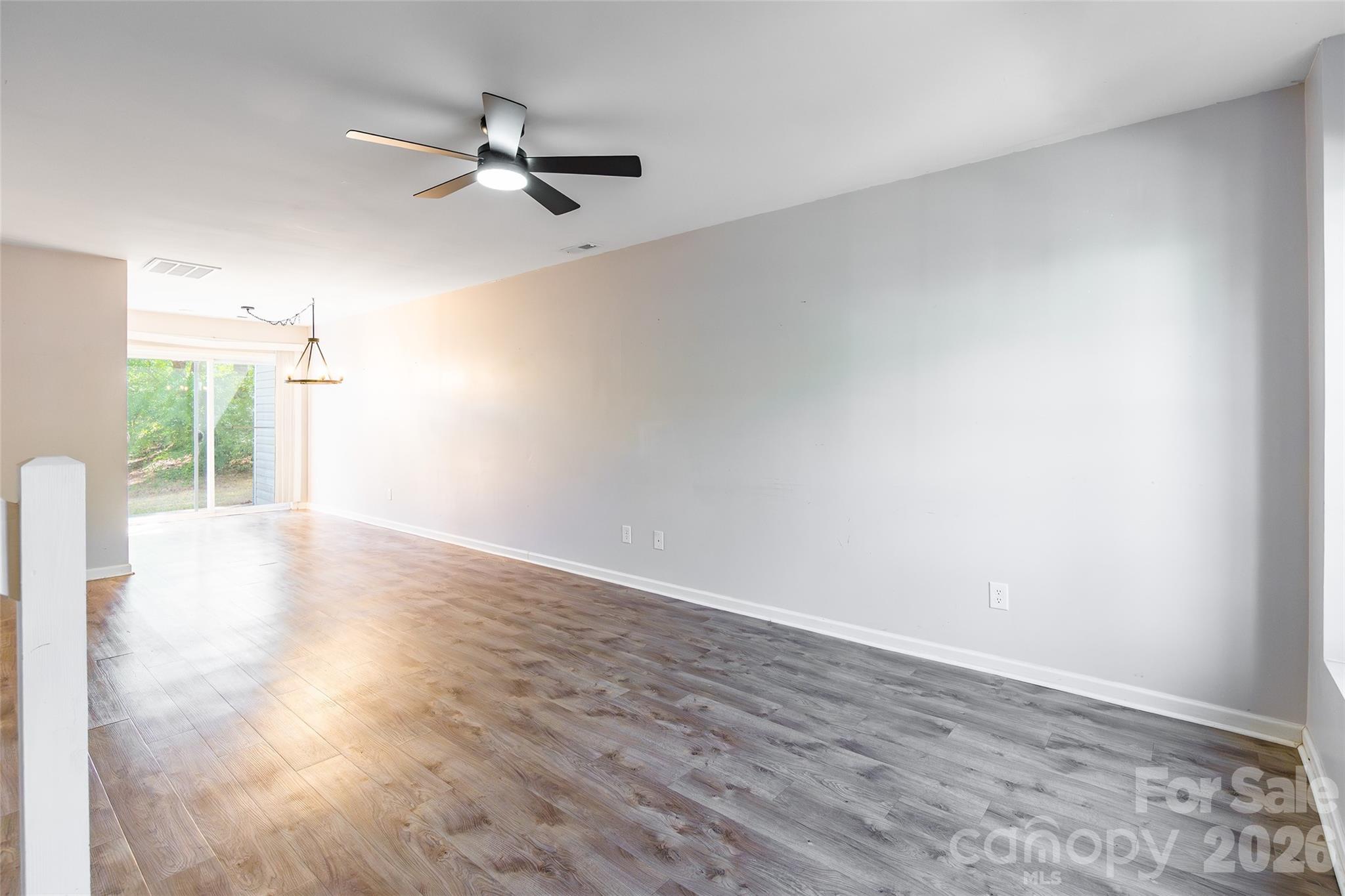 4024 Ashby Lane Fort Mill, SC 29707 - Photo 2 of 21 a view of a livingroom with a ceiling fan and wooden floor