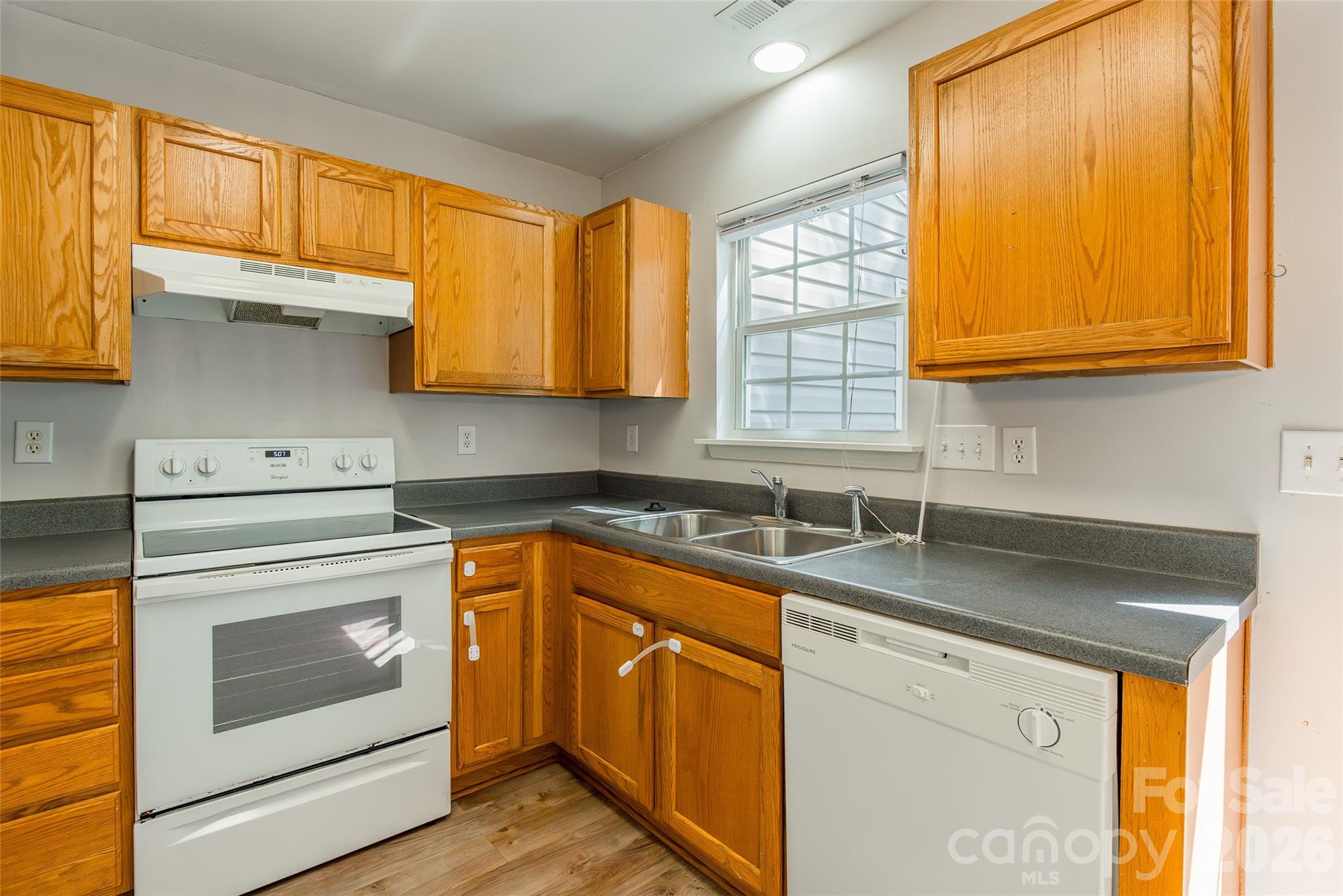 4024 Ashby Lane Fort Mill, SC 29707 - Photo 8 of 21 a kitchen with granite countertop cabinets stainless steel appliances a sink and a window