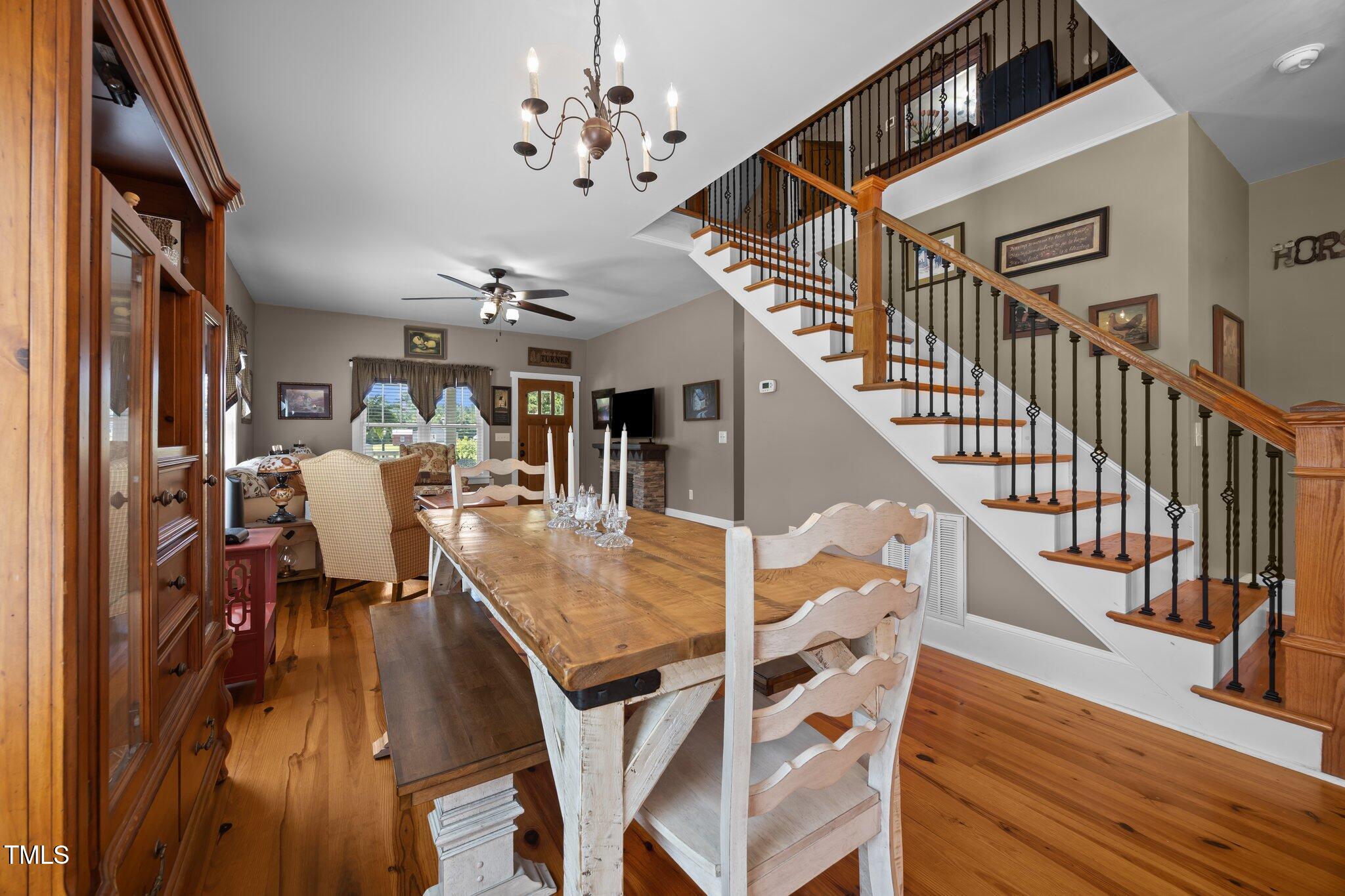 4050 Culbreth Road Stem, NC 27581 - Photo 18 of 46 a view of a dining room with furniture wooden floor and chandelier