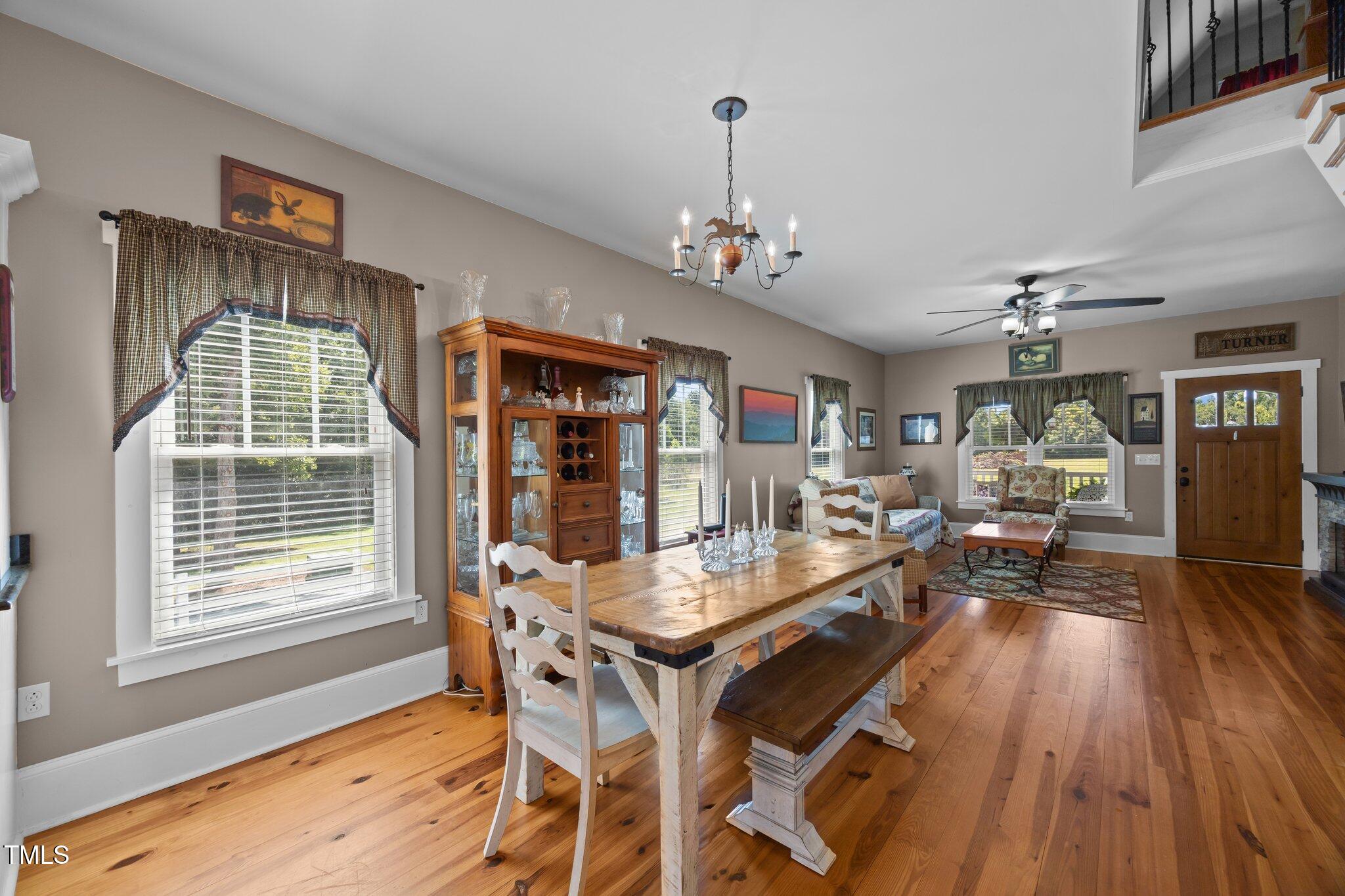 4050 Culbreth Road Stem, NC 27581 - Photo 19 of 46 a view of a dining room with furniture window and wooden floor
