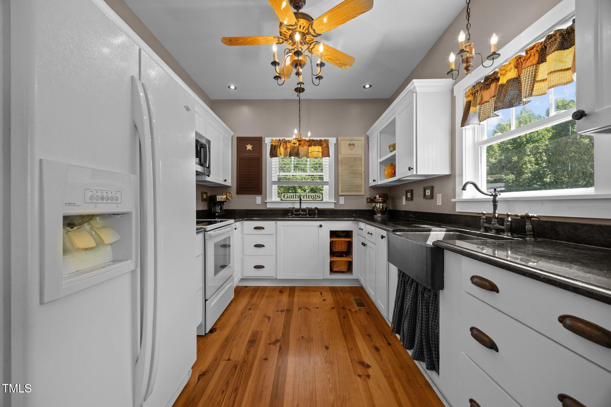 4050 Culbreth Road Stem, NC 27581 - Photo 20 of 46 a kitchen with stainless steel appliances granite countertop a sink cabinets a counter top space and a window