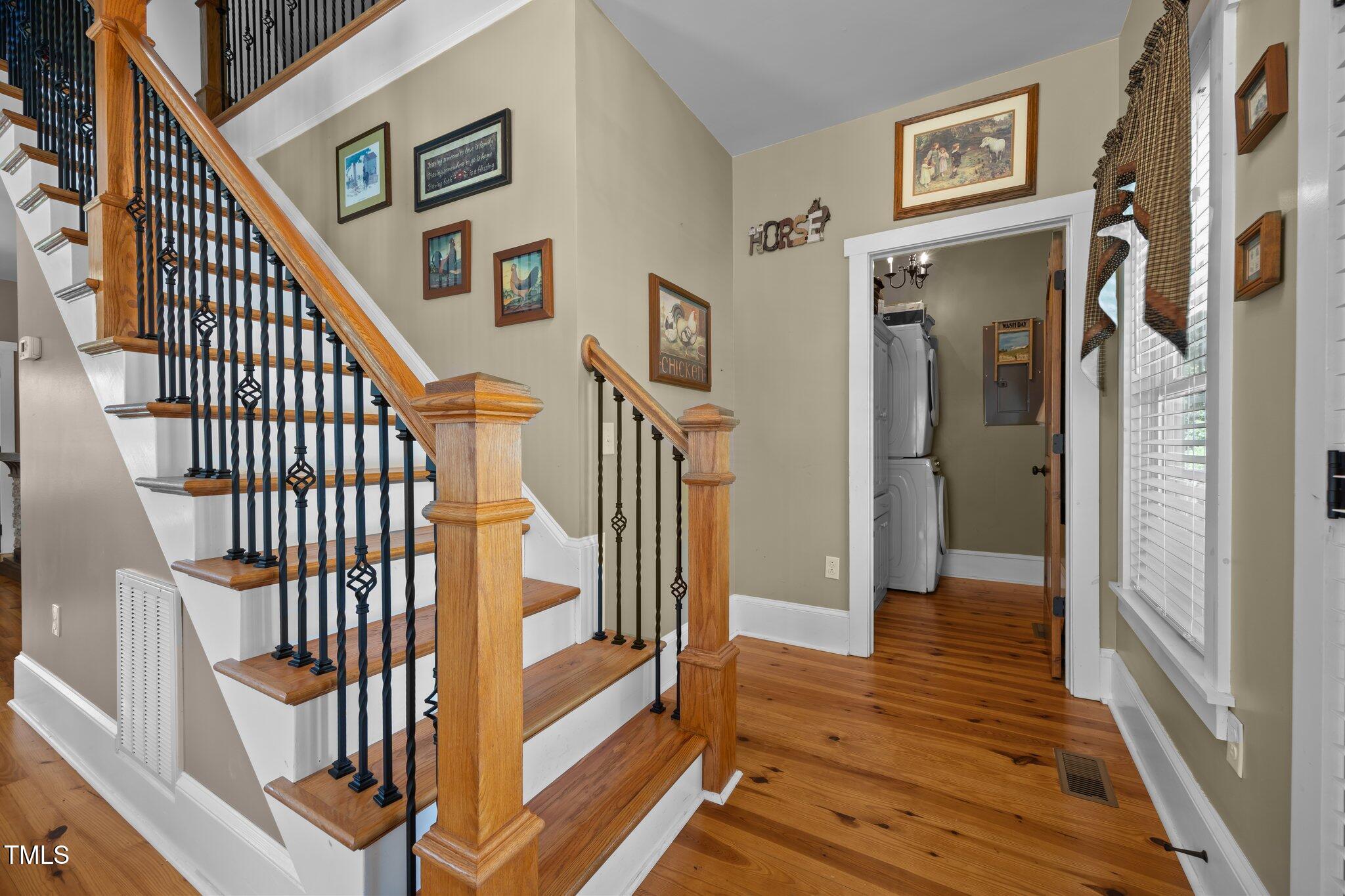 4050 Culbreth Road Stem, NC 27581 - Photo 23 of 46 a view of a hallway with wooden floor and windows