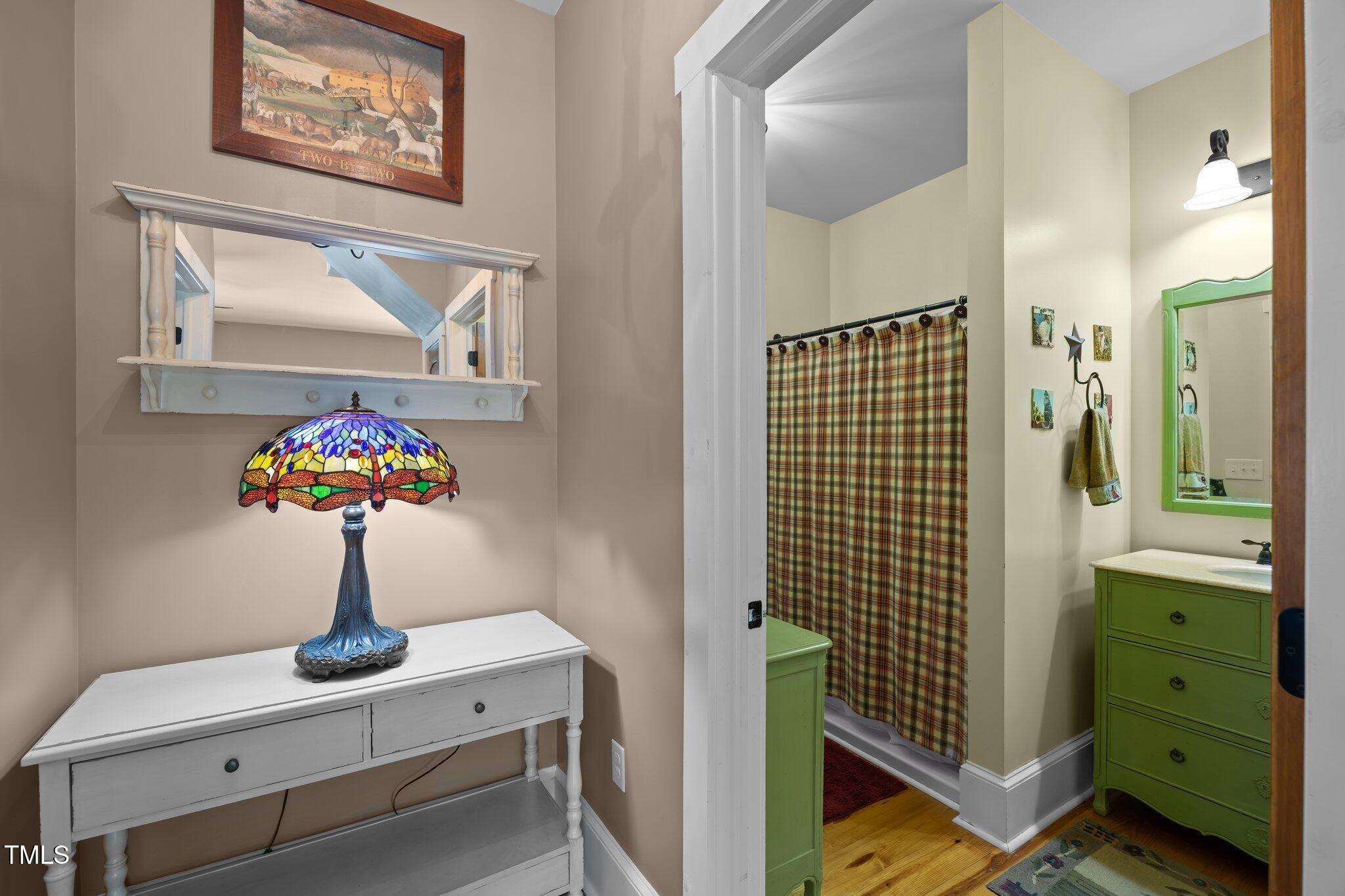 4050 Culbreth Road Stem, NC 27581 - Photo 25 of 46 a bathroom with a sink mirror and vanity