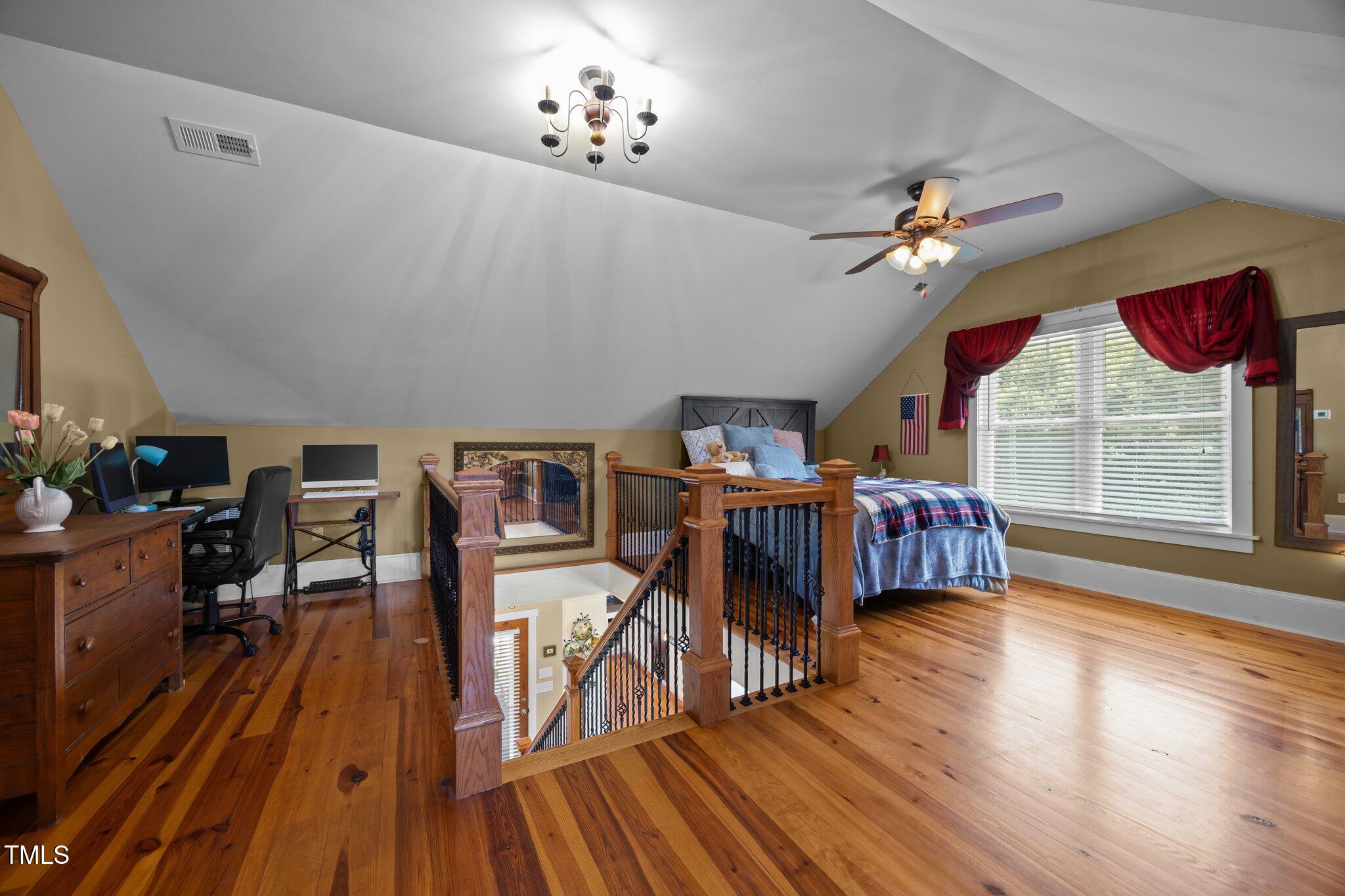 4050 Culbreth Road Stem, NC 27581 - Photo 28 of 46 a bedroom with furniture and a chandelier