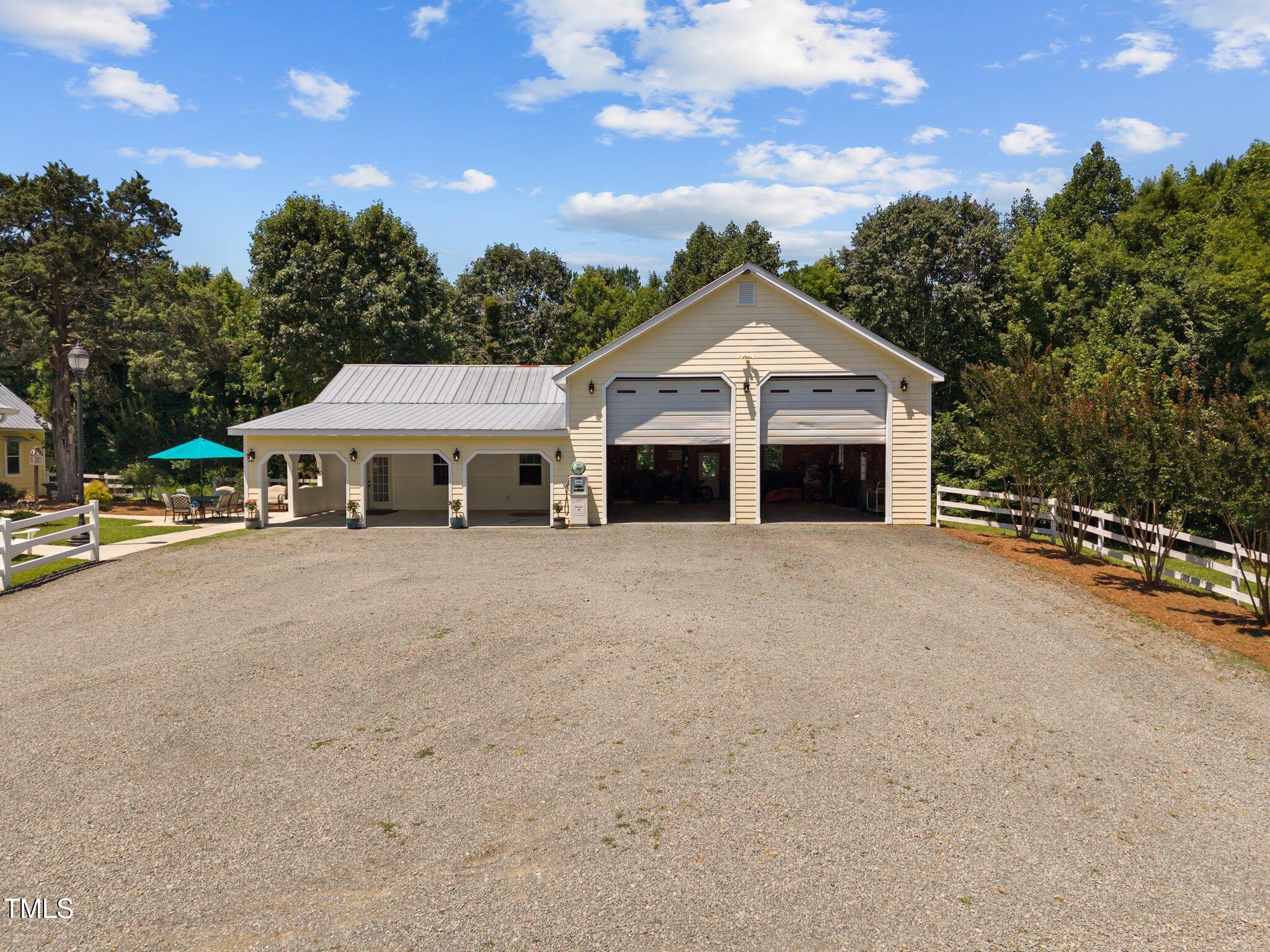 4050 Culbreth Road Stem, NC 27581 - Photo 3 of 46 a front view of a house with a yard and garage