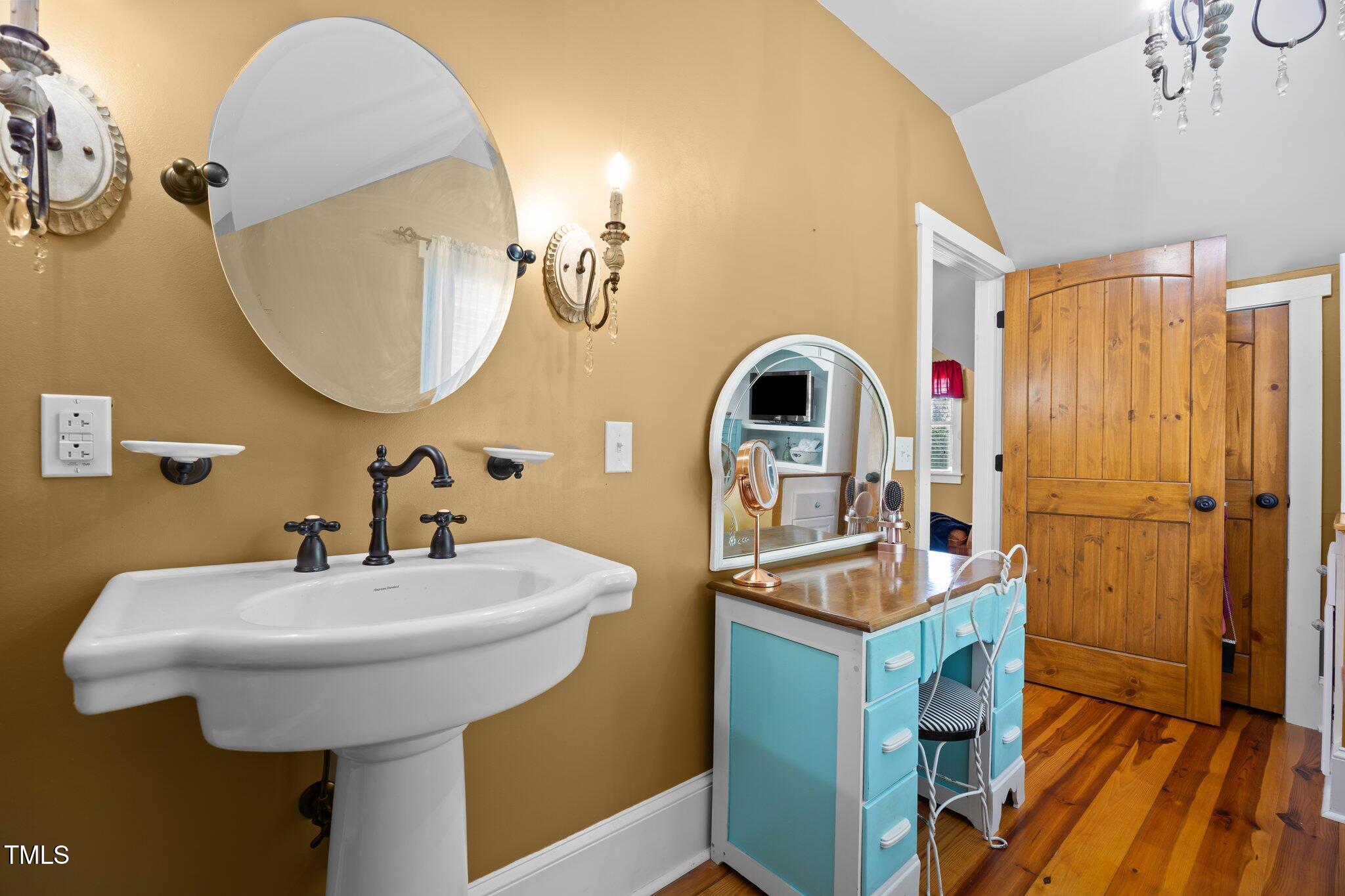 4050 Culbreth Road Stem, NC 27581 - Photo 32 of 46 a bathroom with a sink a mirror and a toilet