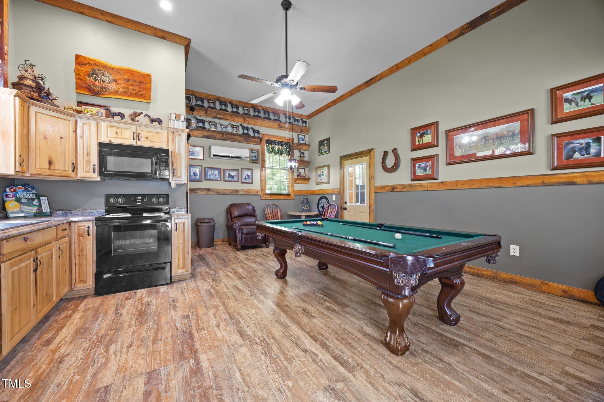 4050 Culbreth Road Stem, NC 27581 - Photo 37 of 46 a kitchen with furniture wooden floor and appliances