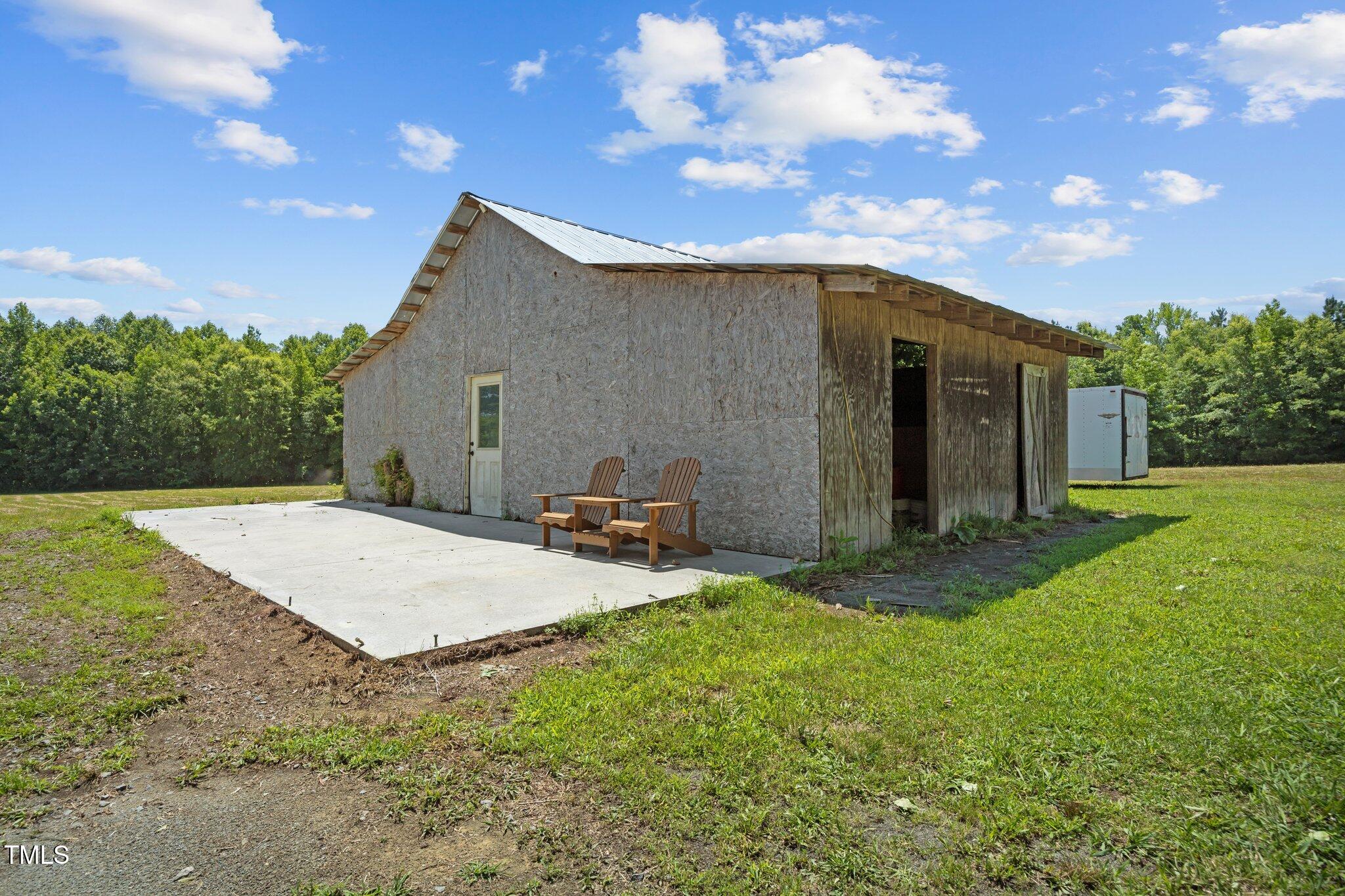 4050 Culbreth Road Stem, NC 27581 - Photo 45 of 46 a backyard of a house with table and sofas