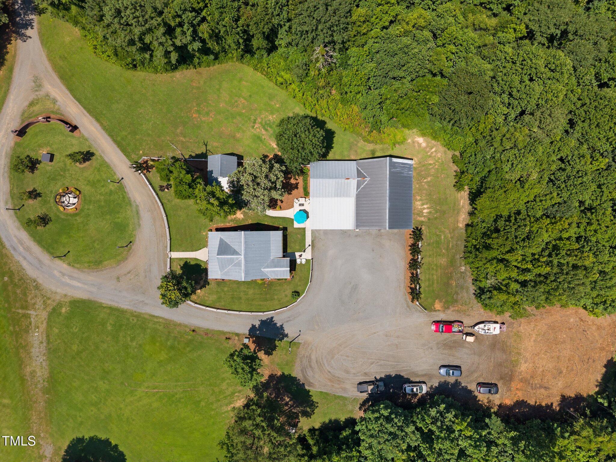 4050 Culbreth Road Stem, NC 27581 - Photo 6 of 46 an aerial view of a house with outdoor space pool seating area and garage