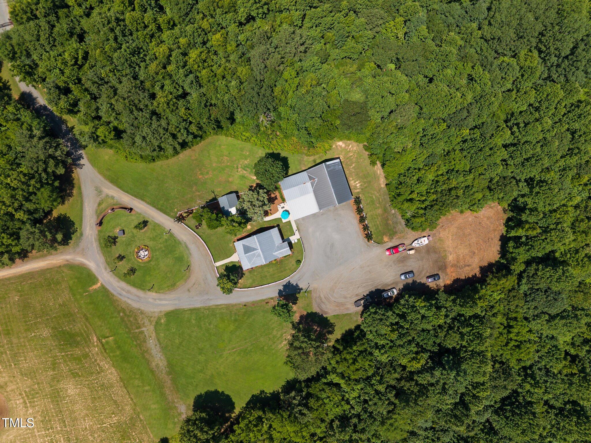 4050 Culbreth Road Stem, NC 27581 - Photo 7 of 46 an aerial view of a house with a swimming pool