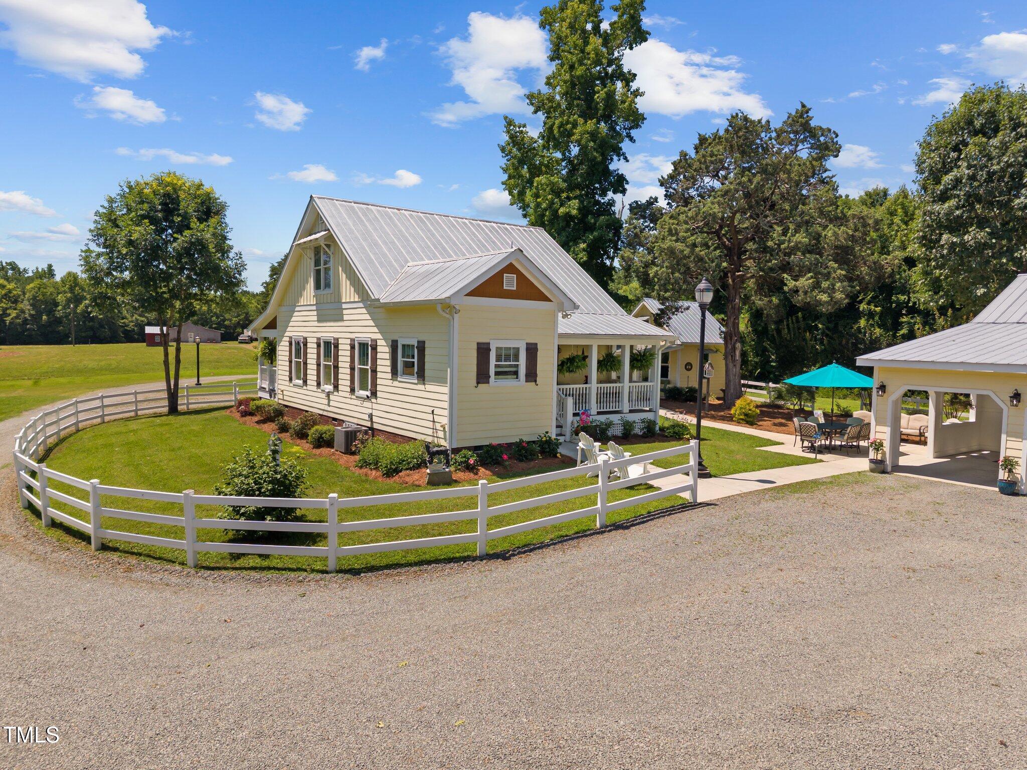 4050 Culbreth Road Stem, NC 27581 - Photo 9 of 46 a front view of a house with a swimming pool