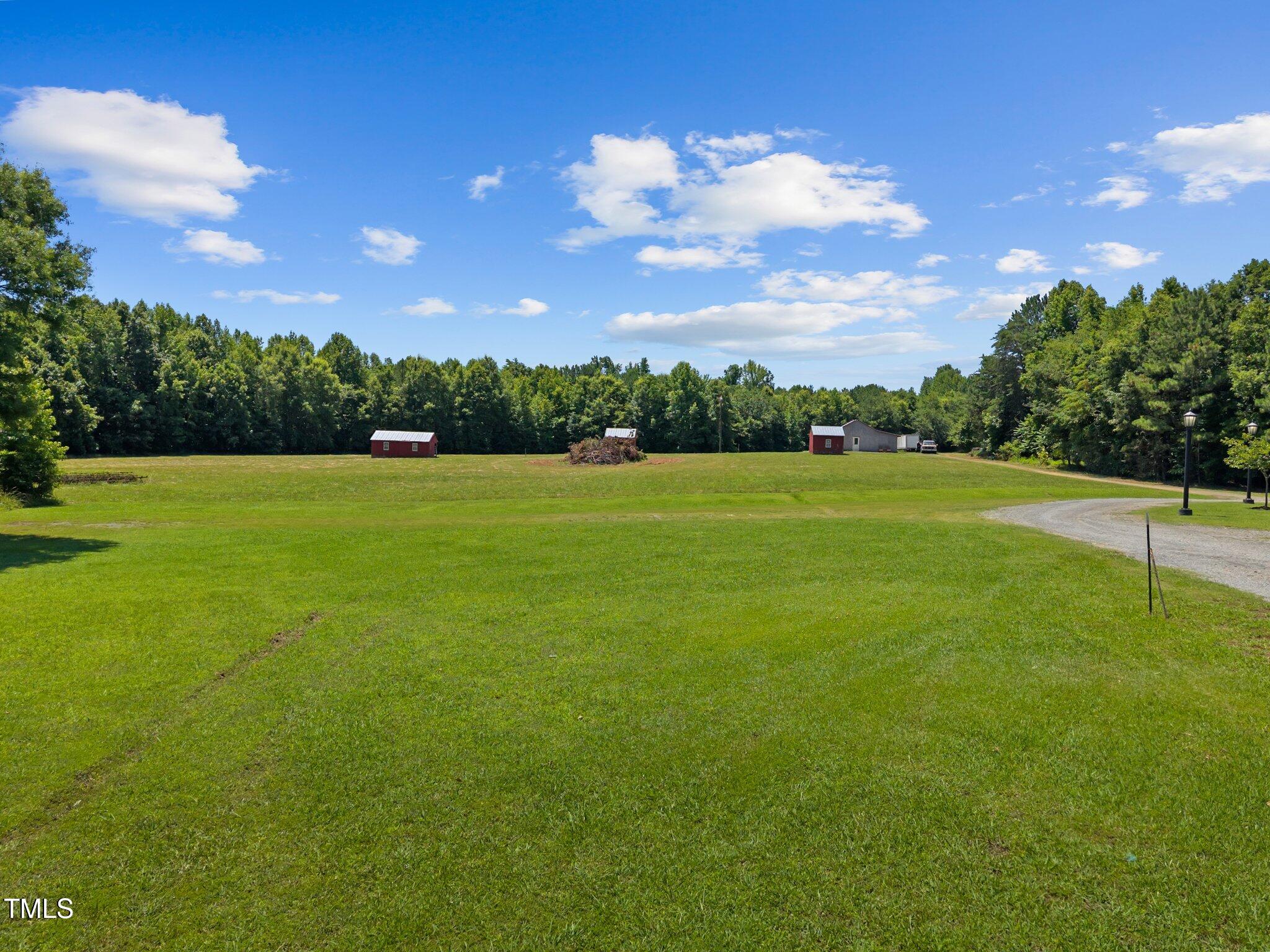 4050 Culbreth Road Stem, NC 27581 - Photo 10 of 46 a view of a big yard with lots of green space and mountain view