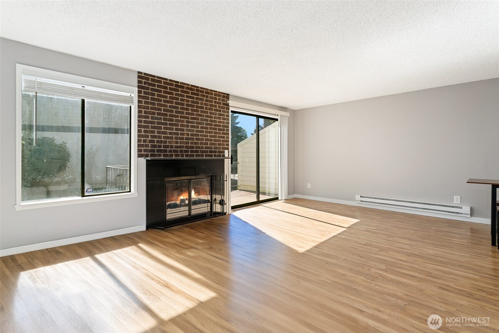 1802 Maple Lane, Unit A5 Kent, WA 98030 - Photo 2 of 27 a view of empty room with wooden floor and fireplace